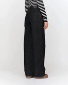 woman wearing dark grey wide-leg jeans