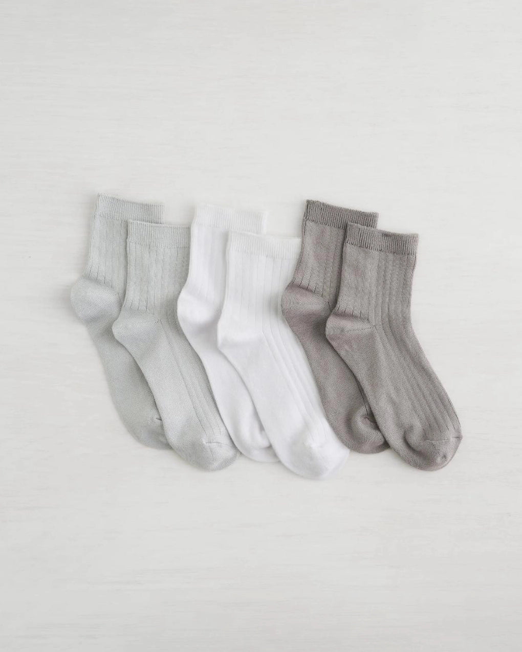 three pack of socks in light grey, white and dark grey