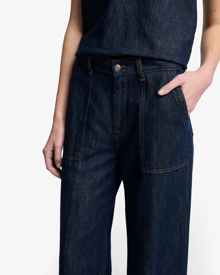 close up of woman wearing dark blue wide-leg jeans by 7 for all mankind with utility pockets