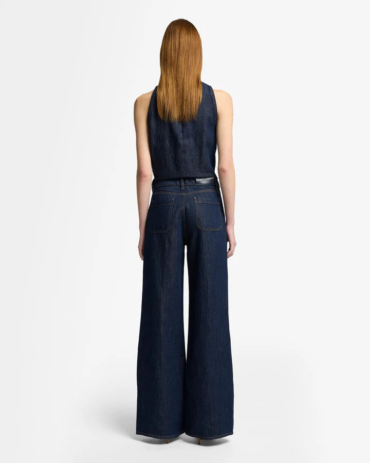 woman wearing dark blue wide-leg jeans by 7 for all mankind with utility pockets