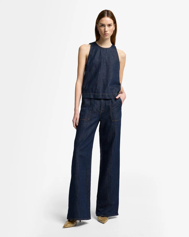 woman wearing dark blue wide-leg jeans by 7 for all mankind with utility pockets