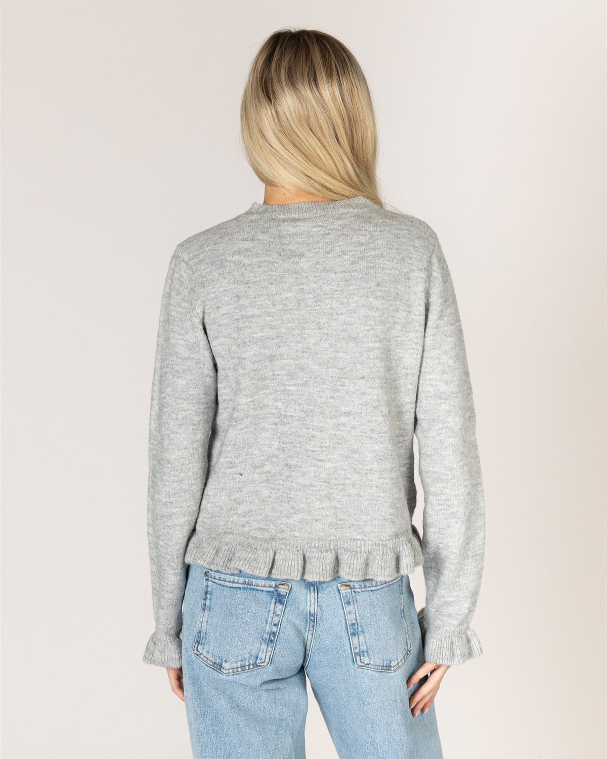grey cardigan with ruffles down the middle and on sleeves