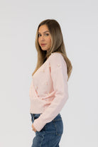 pink wrap sweater with pearls