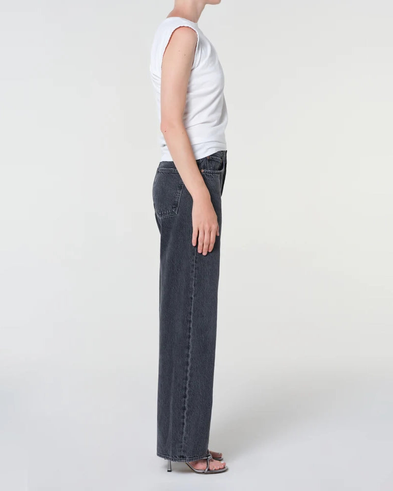A woman wearing black wide-leg jeans