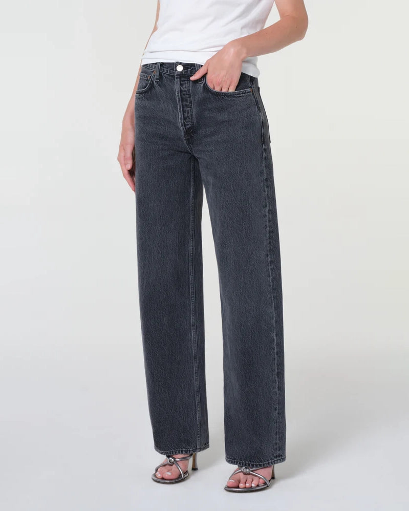 A woman wearing black wide-leg jeans