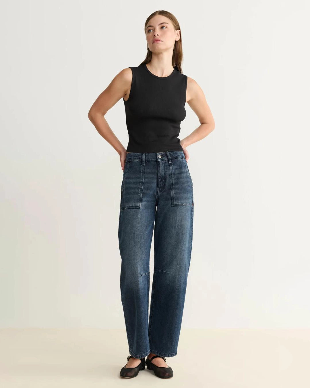 woman wearing barrel blue jeans