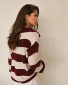 Woman wearing a maroon and white striped fluffy sweater
