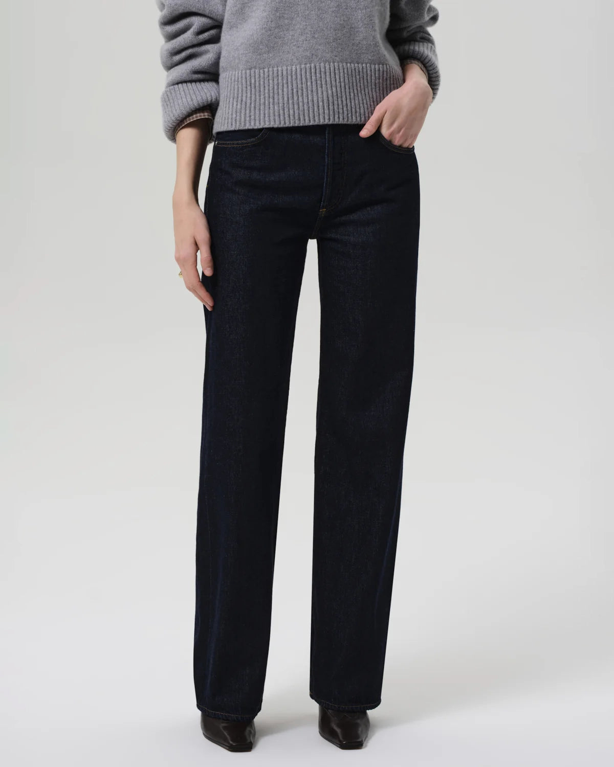 a woman wears a dark wash straight legged jean by Citizens of Humanity