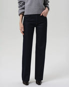 a woman wears a dark wash straight legged jean by Citizens of Humanity