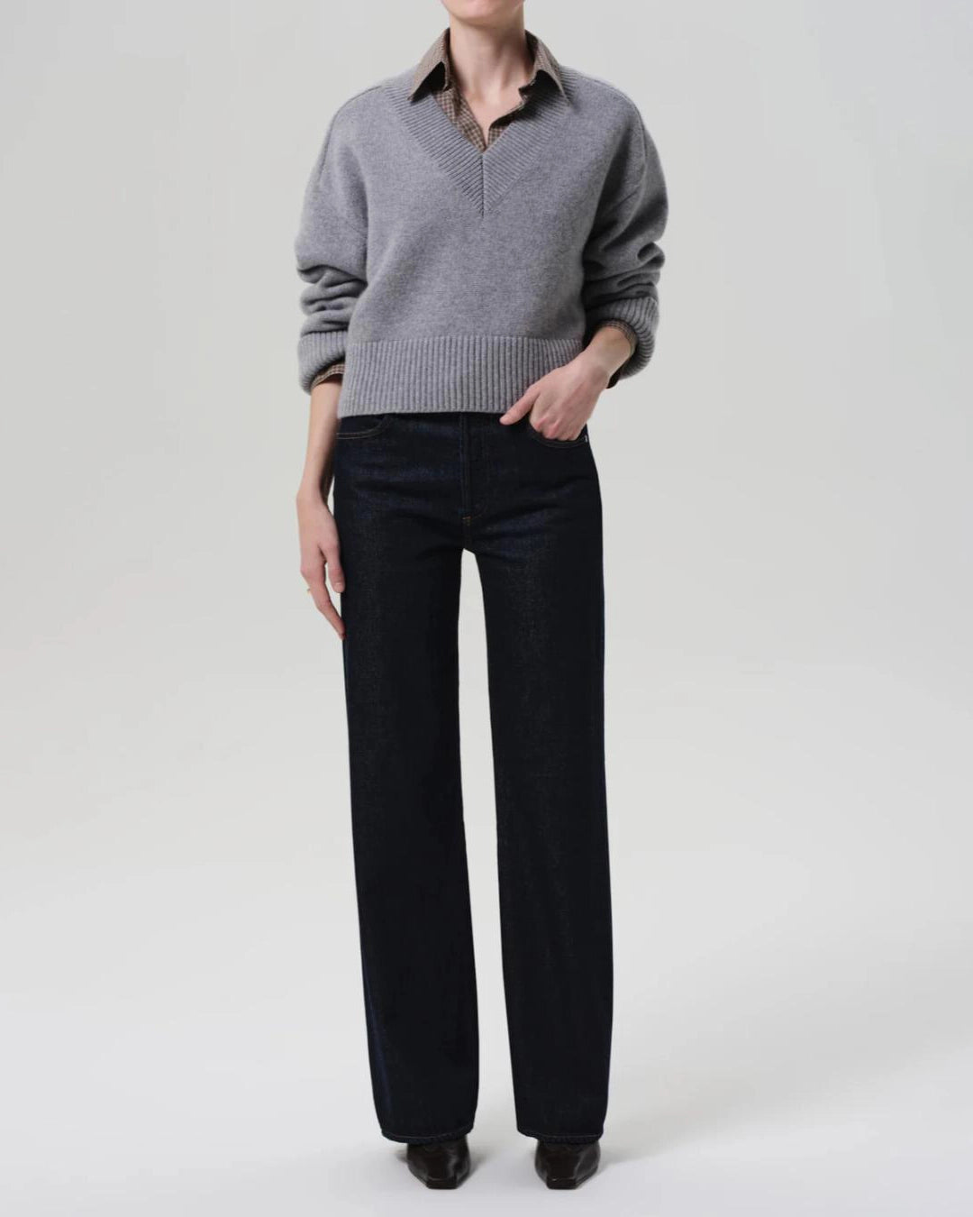 a woman wears a dark wash straight legged jean by Citizens of Humanity