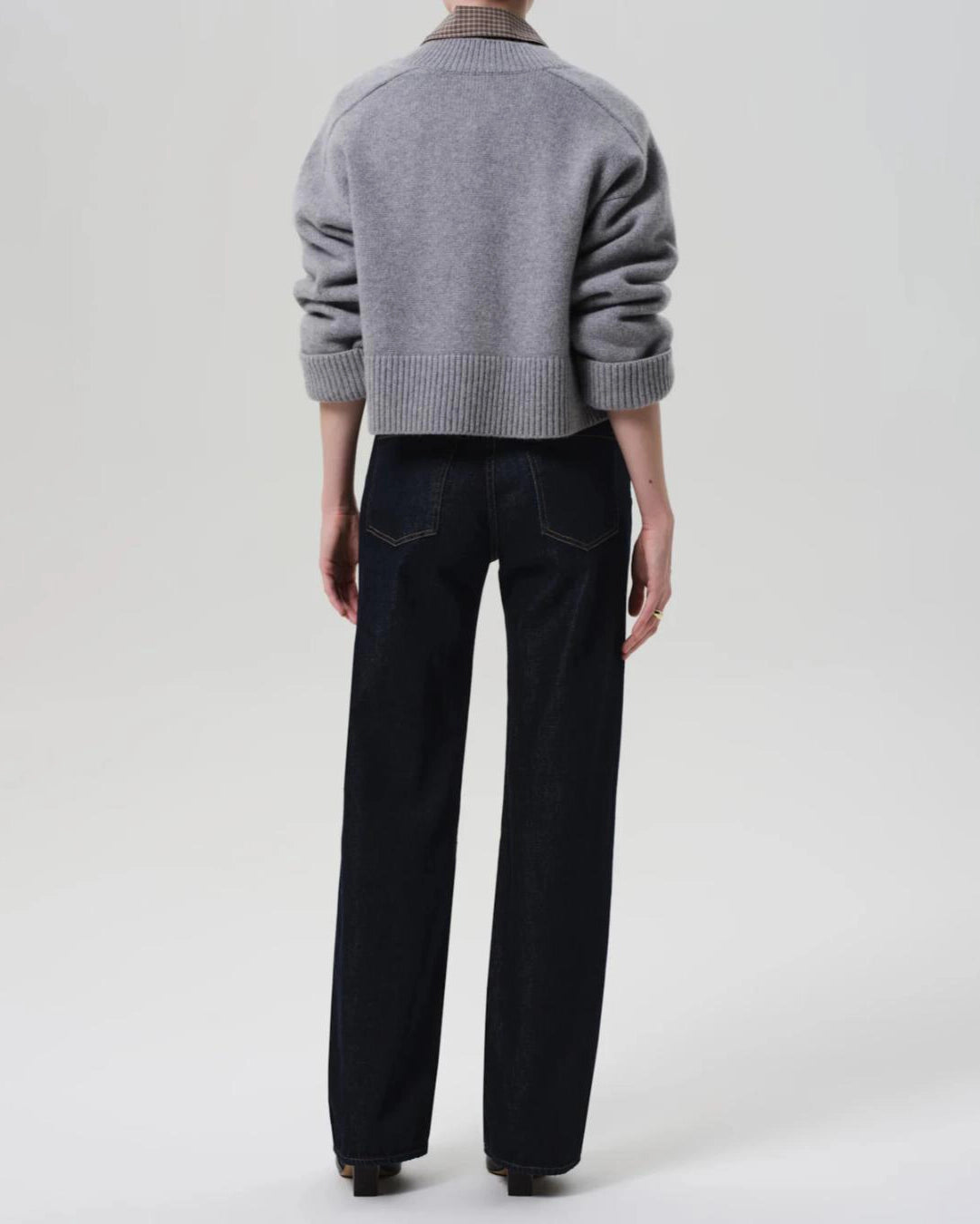 a woman wears a dark wash straight legged jean by Citizens of Humanity