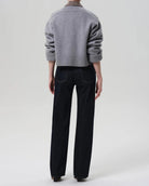 a woman wears a dark wash straight legged jean by Citizens of Humanity