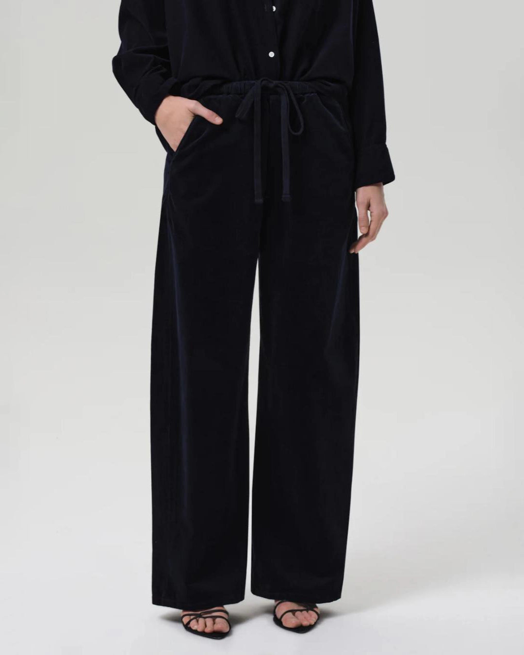 a woman wearing a pair of navy blue corduroy drawstring pants by Citizens of Humanity
