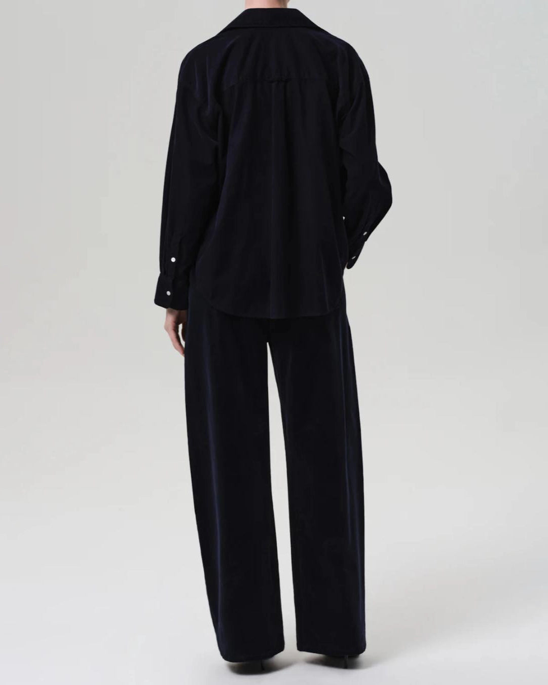 a woman wearing a pair of navy blue corduroy drawstring pants by Citizens of Humanity