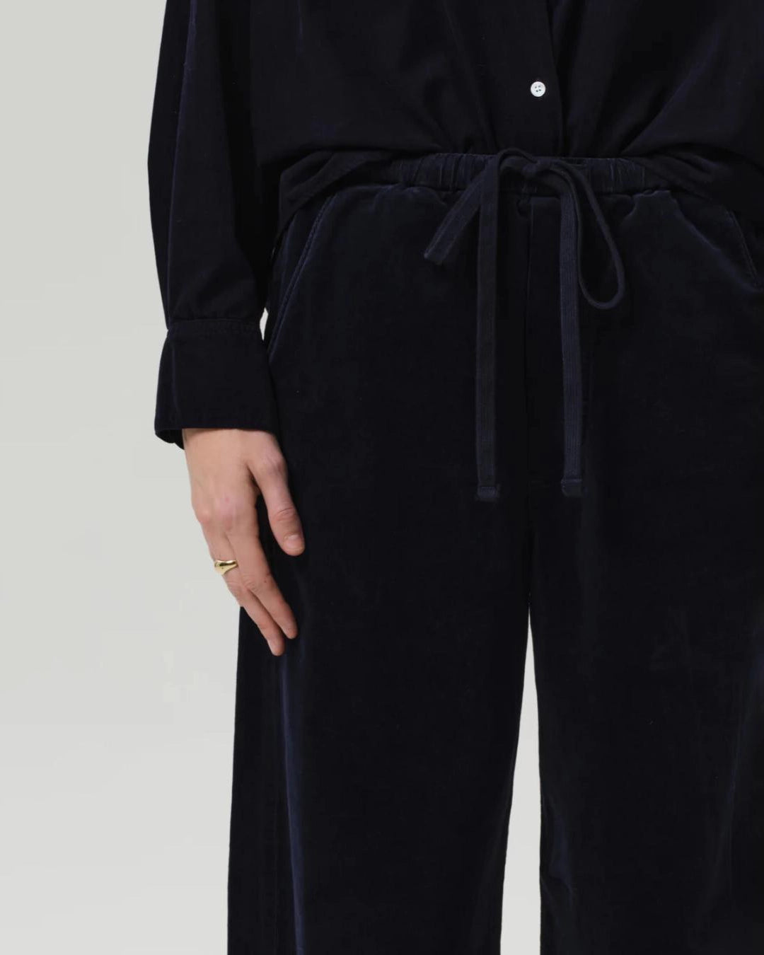 a woman wearing a pair of navy blue corduroy drawstring pants by Citizens of Humanity