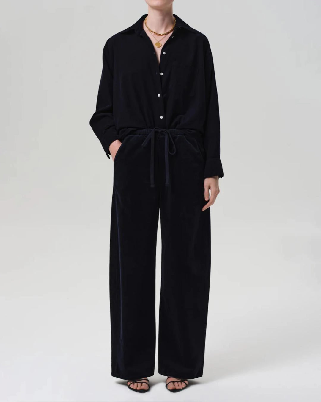 a woman wearing a pair of navy blue corduroy drawstring pants by Citizens of Humanity