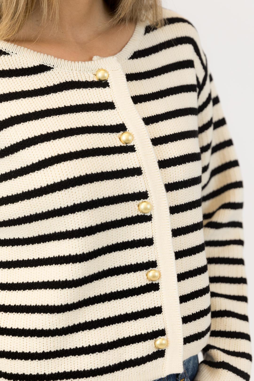 close up of a black and white striped cardigan