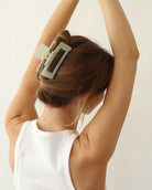 Person with a mint green hair clip in their hair