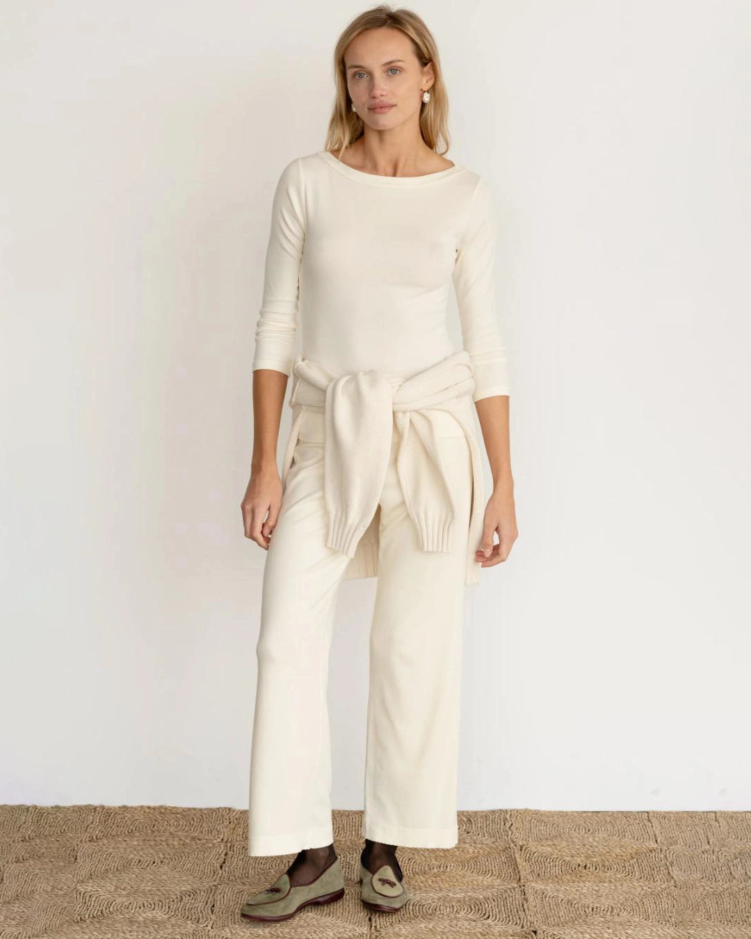 a woman wearing a ribbed boatneck top in cream