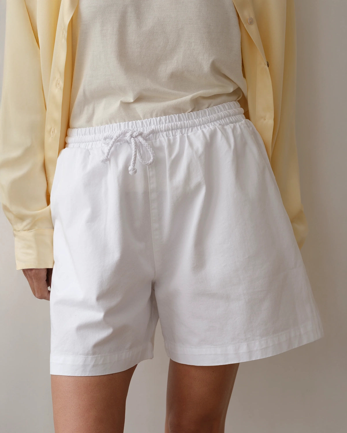 Woman wearing chino drawstring shorts in white
