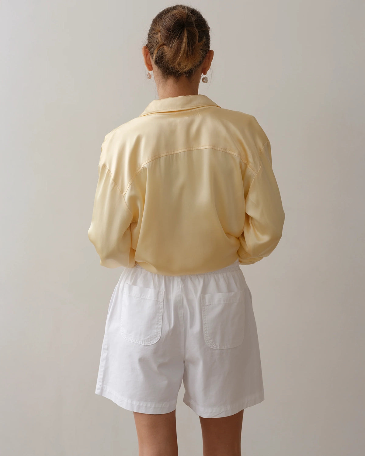 Woman wearing chino drawstring shorts in white