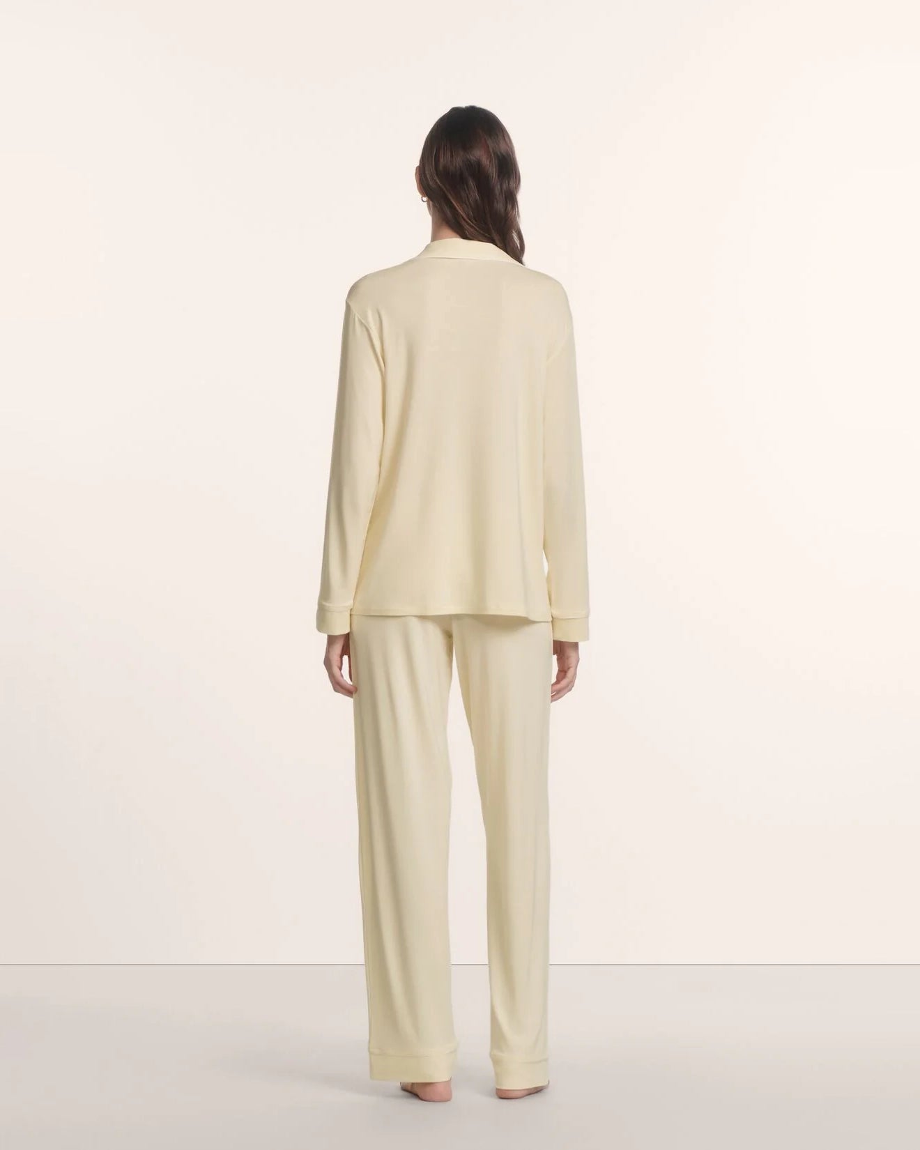 Woman wearing a light yellow pajama set