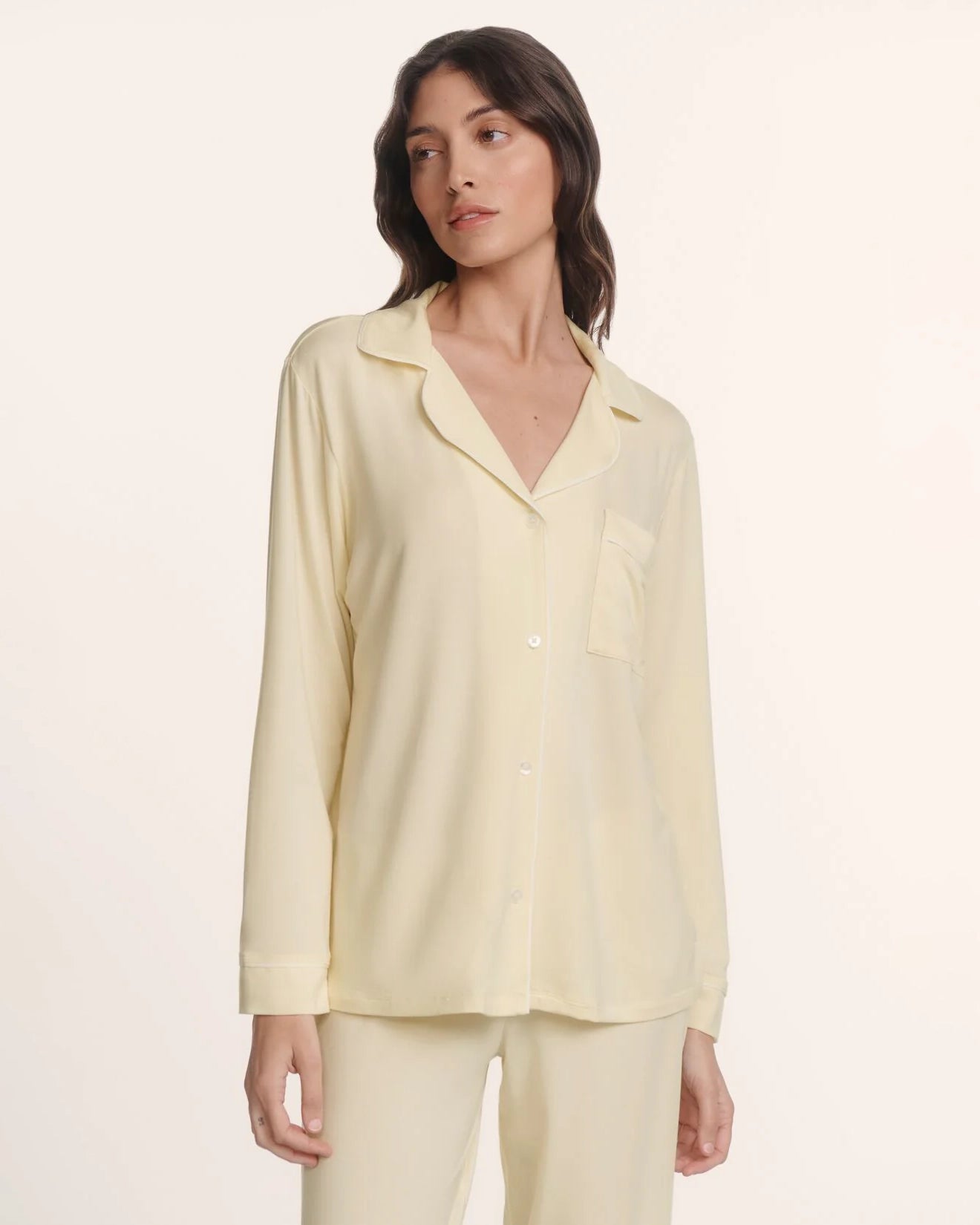 Woman wearing a light yellow pajama set