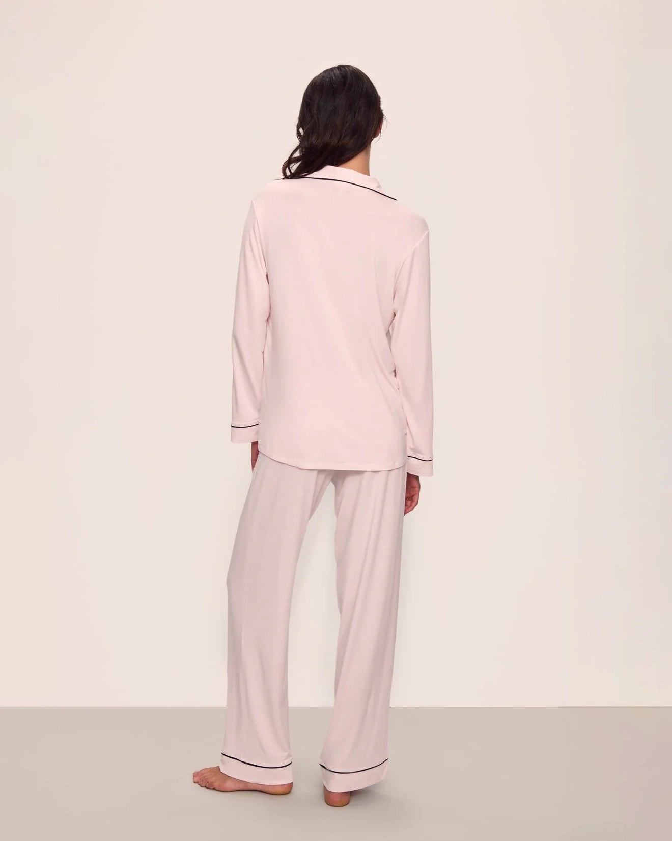 Woman wearing pink tencel and modal pajamas with black piping by Eberjey