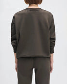 Woman wearing a sweatshirt in brown from favourite daughter