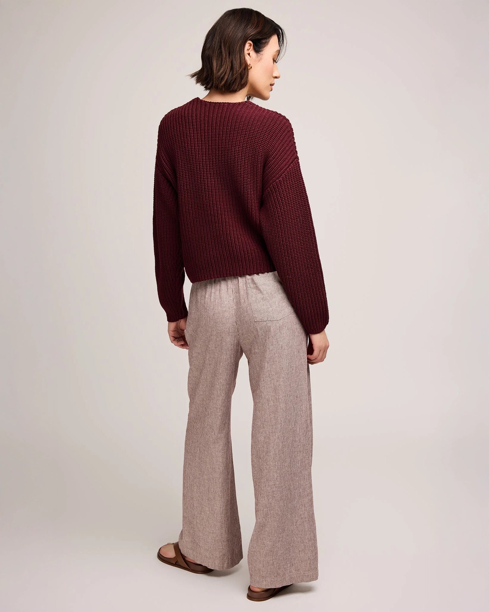 Person wearing burgundy stripe wide-leg linen pants