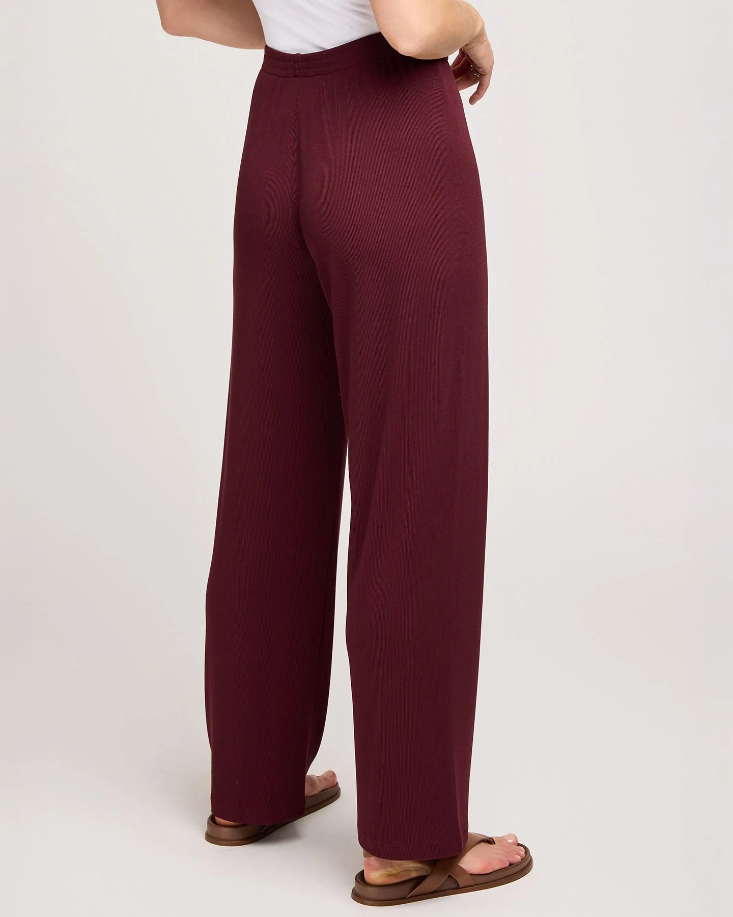 a woman wearing ribbed maroon pants by Gentle Fawn