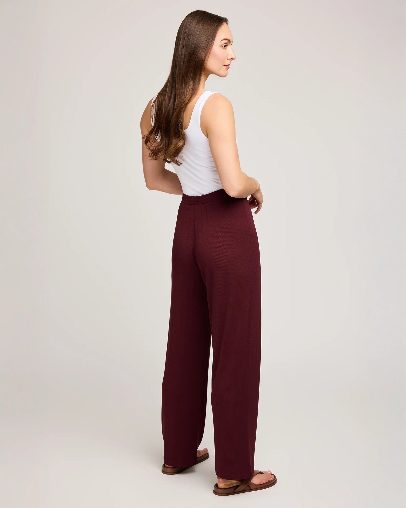 a woman wearing ribbed maroon pants by Gentle Fawn
