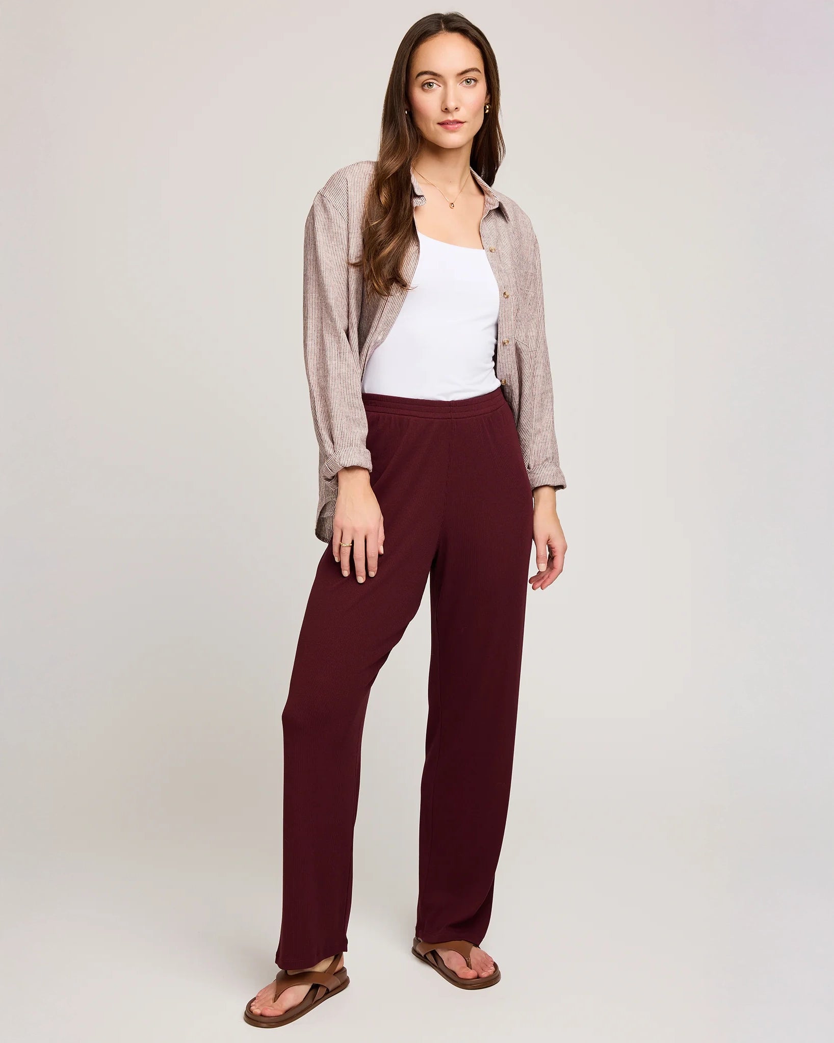 a woman wearing ribbed maroon pants by Gentle Fawn