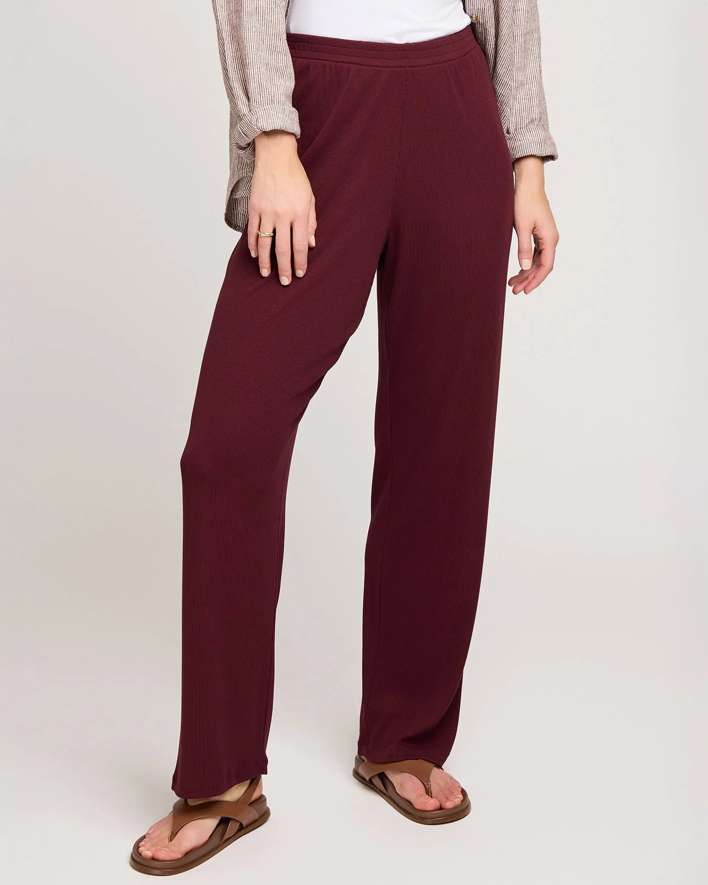 a woman wearing ribbed maroon pants by Gentle Fawn