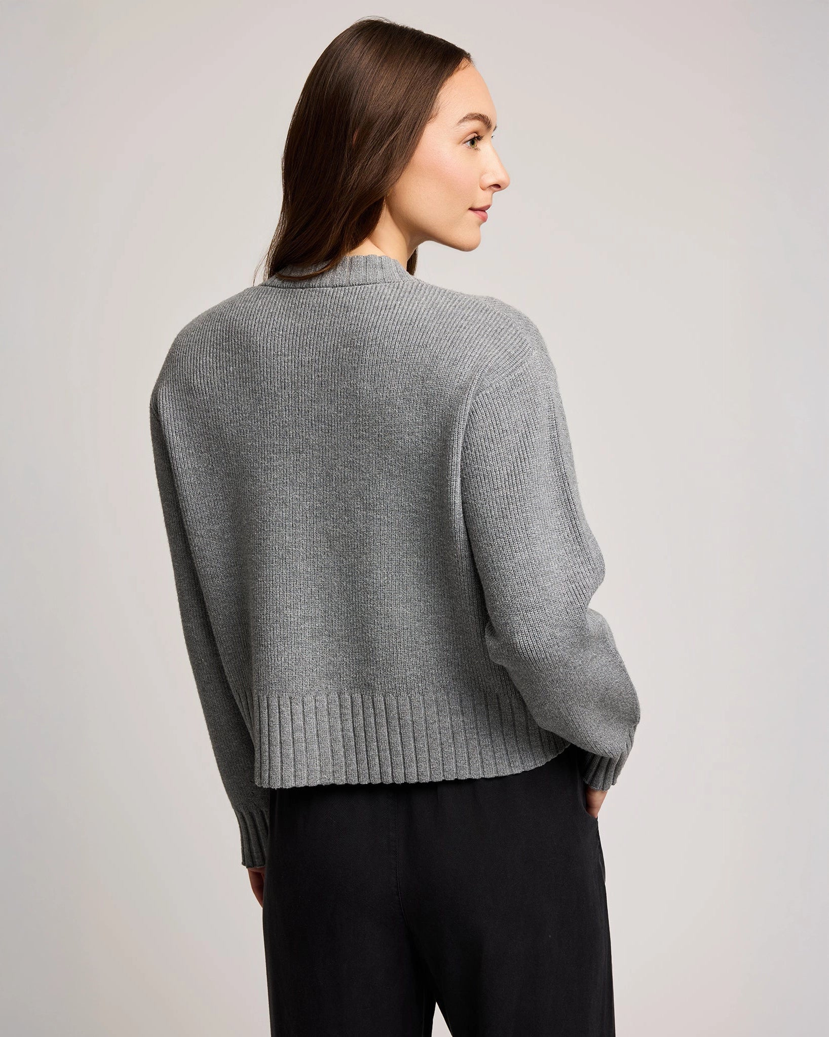 Woman wearing a gray knit button down cardigan