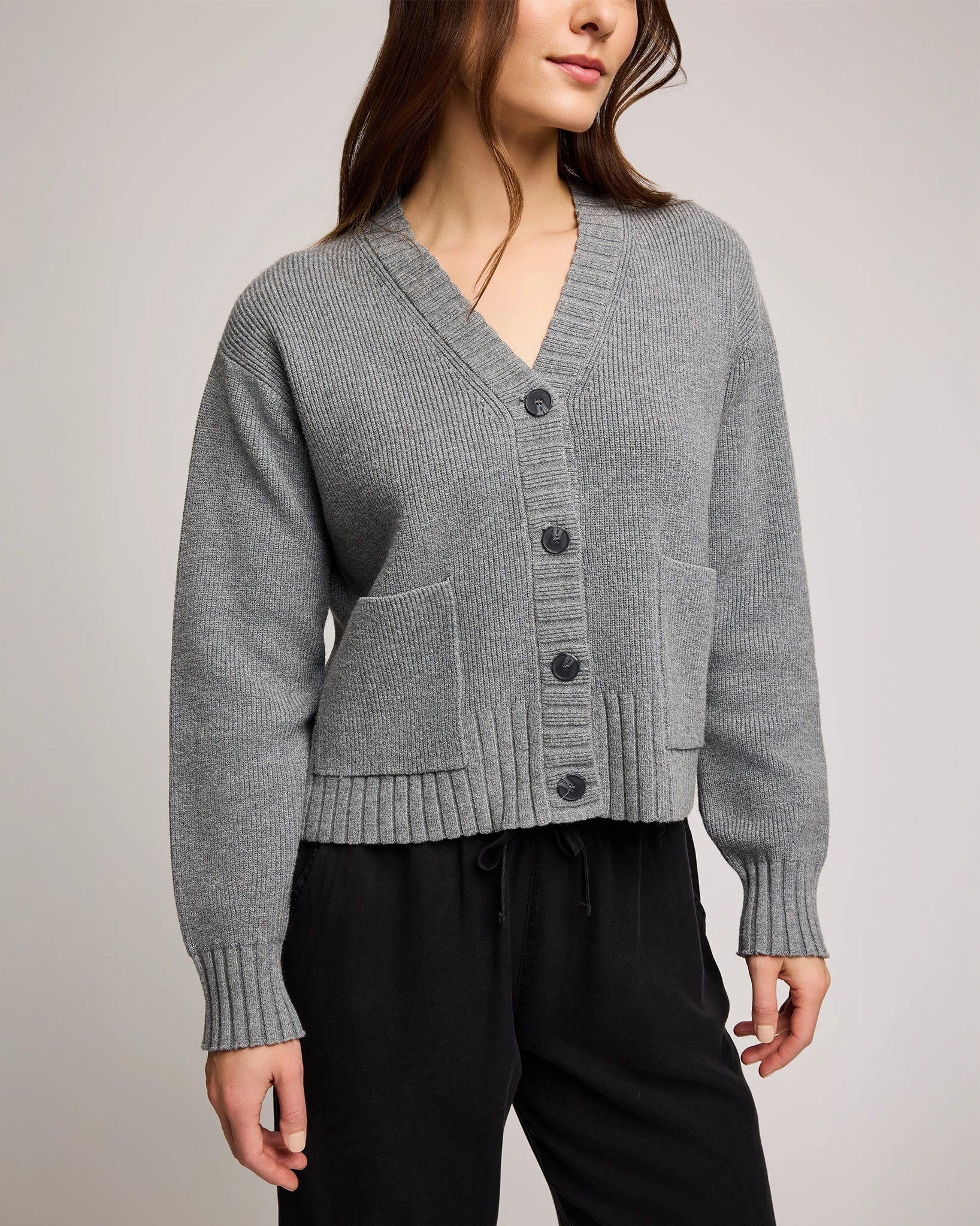 Woman wearing a gray knit button down cardigan