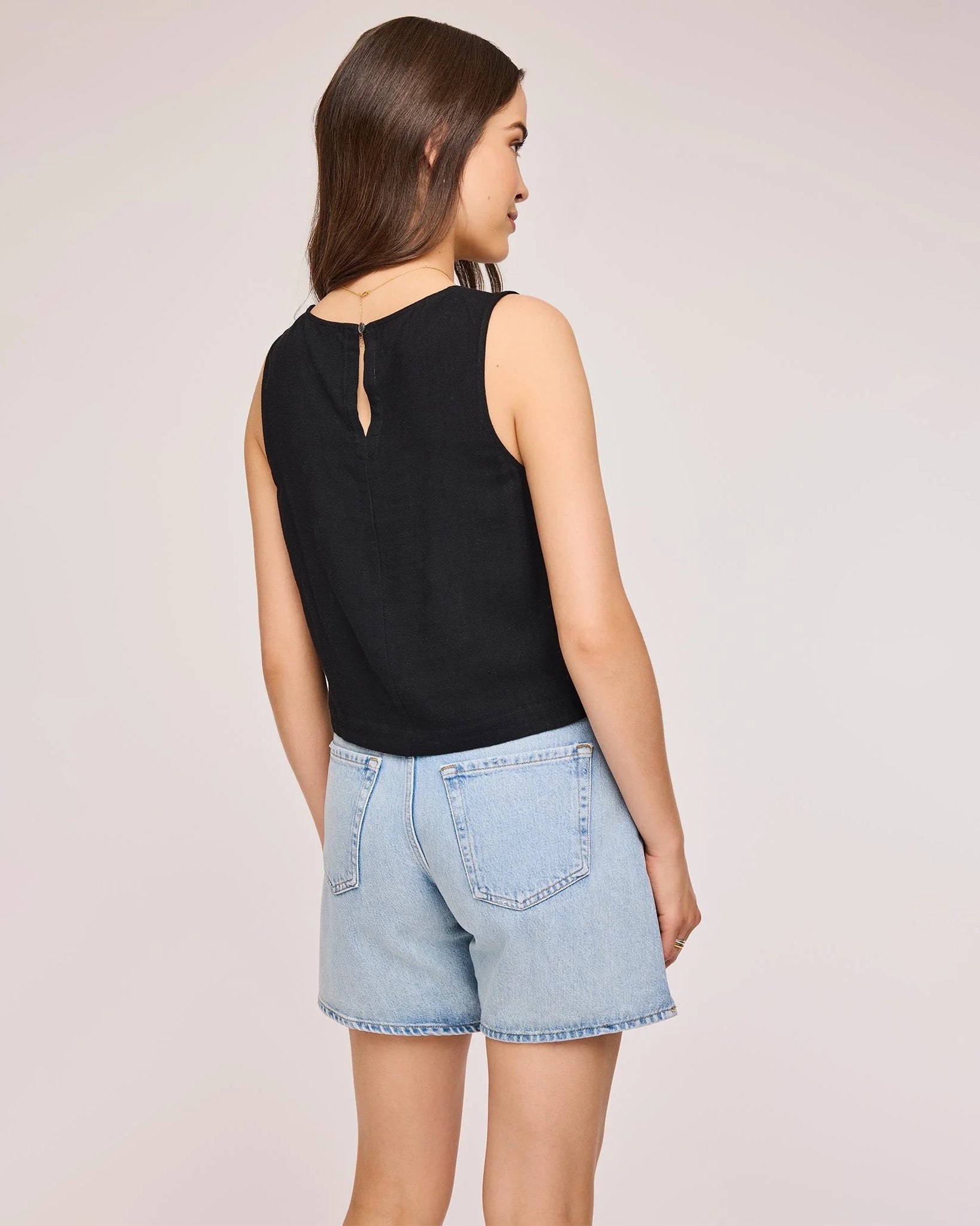 Woman wearing a black sleeveless top