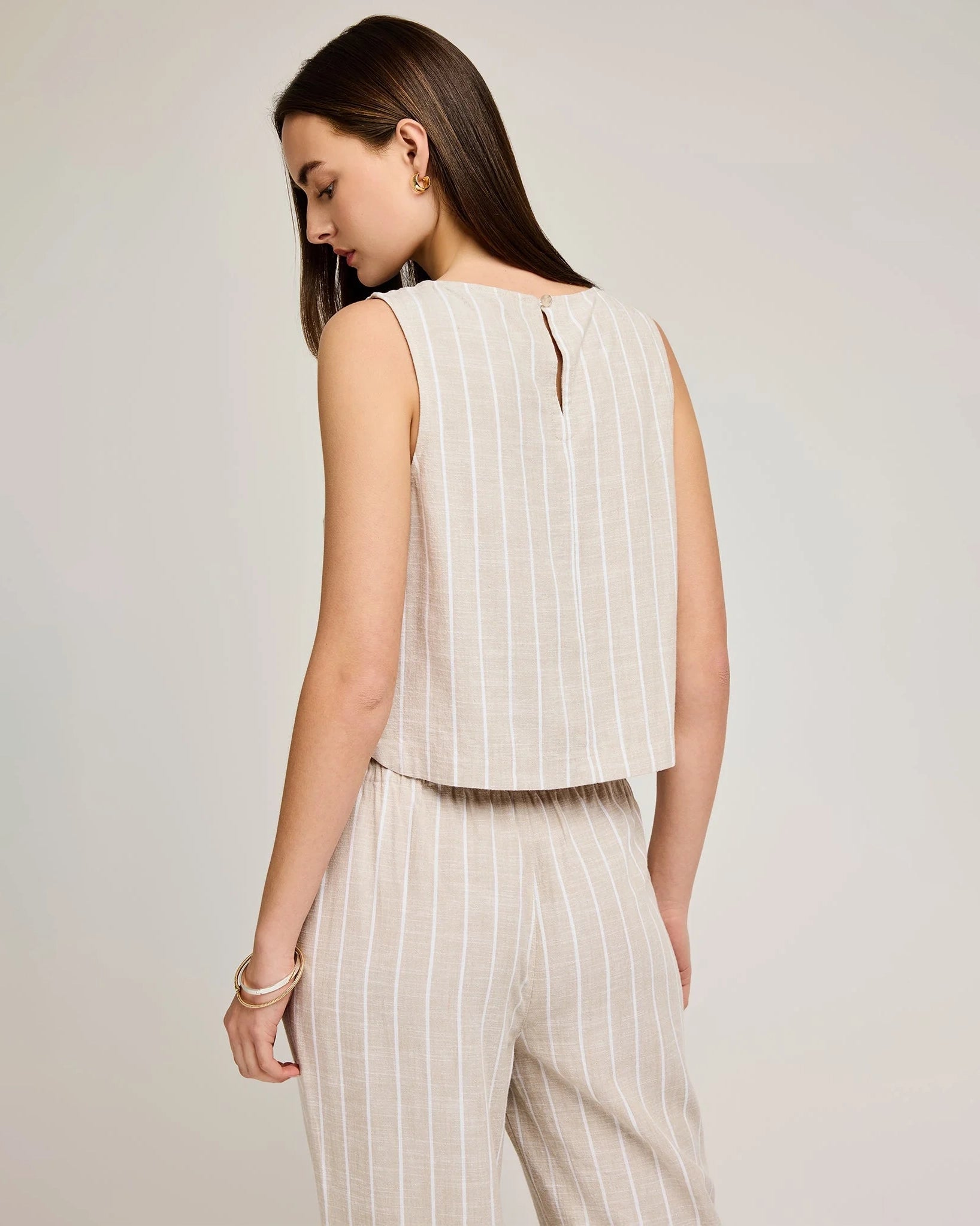 Woman wearing a linen stripe sleeveless top