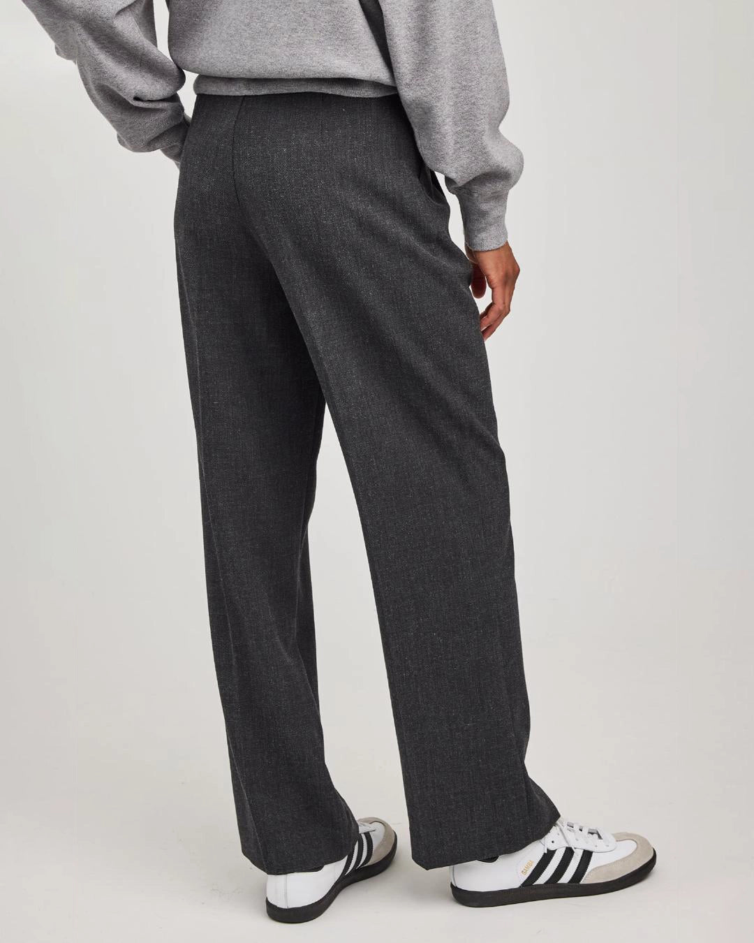 woman wearing grey tailored pants wth center pleat