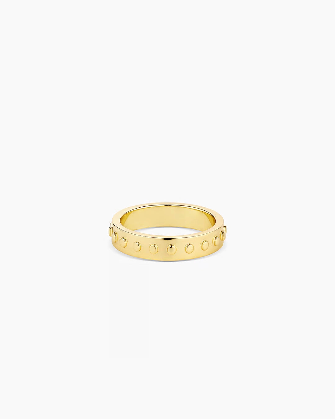 A gold-plated band ring with metallic gold studs and a textured surface.