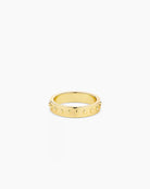 A gold-plated band ring with metallic gold studs and a textured surface.