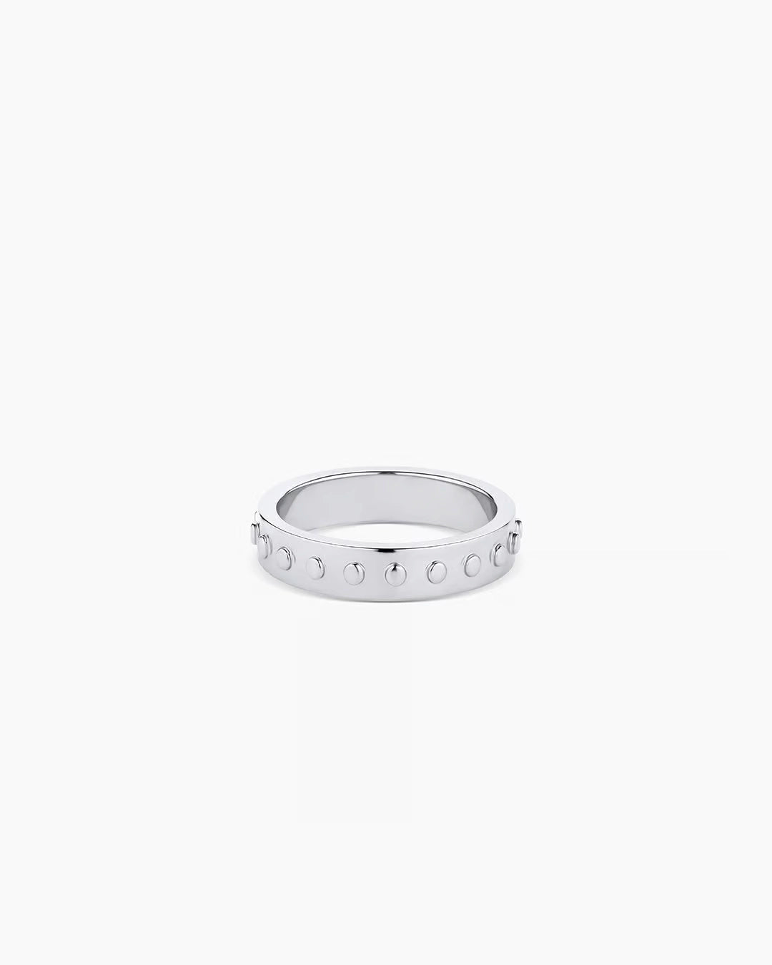 A silver-plated band ring with metallic silver studs and a textured surface.