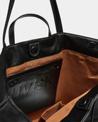 Inside look at HVISK Towny Soft Structure Tote Bag in Black with zip pocket and tan lining