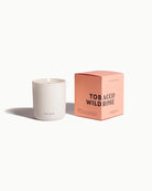 White candle with a pink box labeled 'Tobacco Wild Rose' by Homecoming