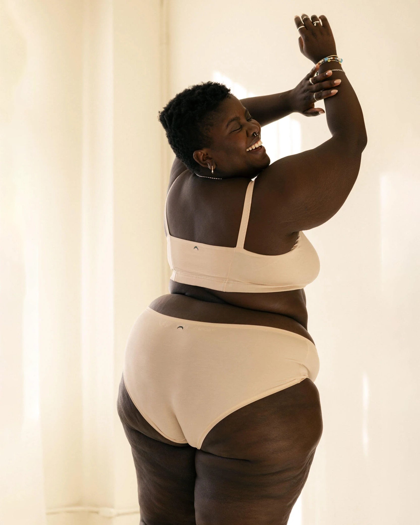 Woman wearing a beige bra and beige hipster boyshort underwear made from tencel