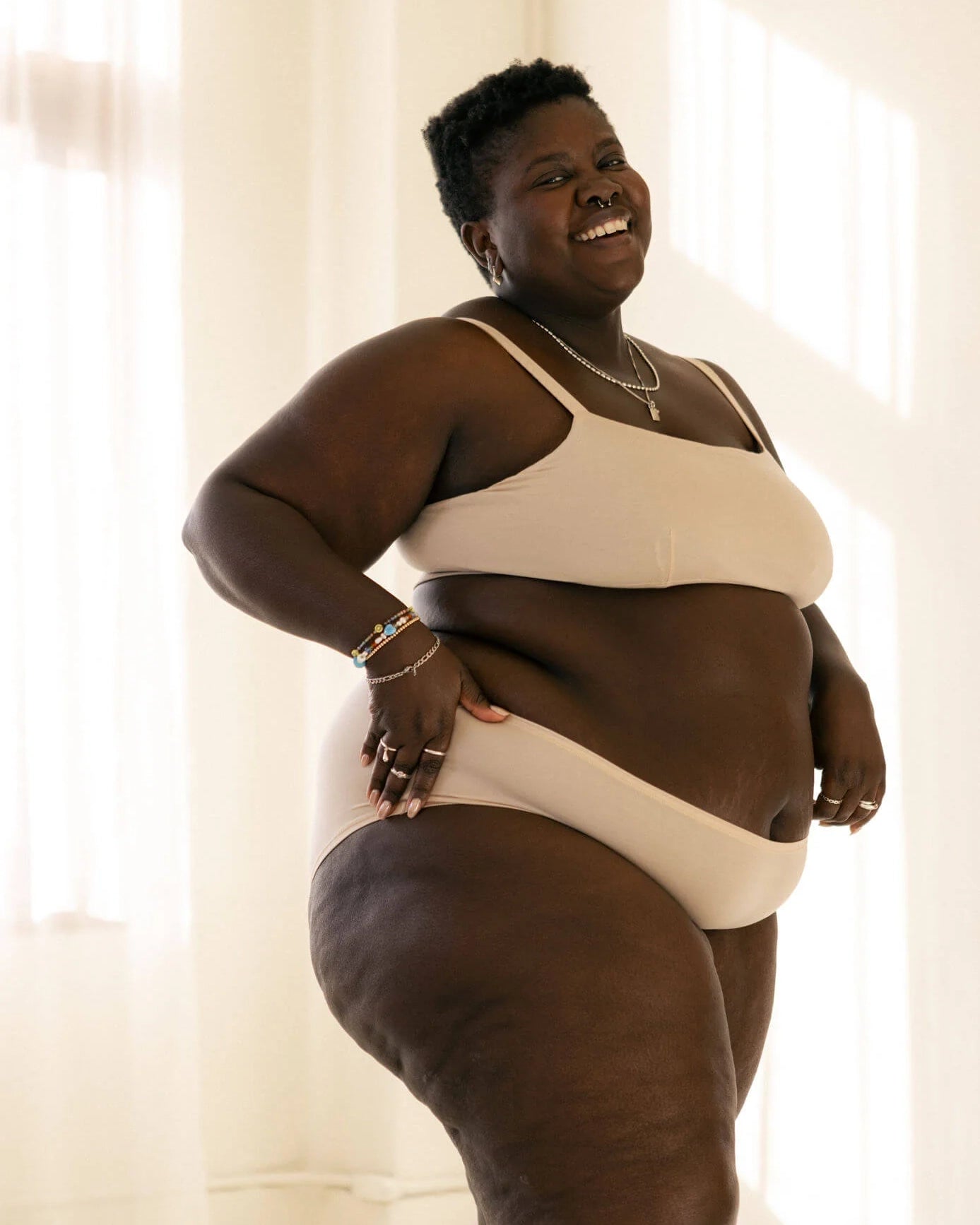 Woman wearing a beige bra and beige hipster boyshort underwear made from tencel