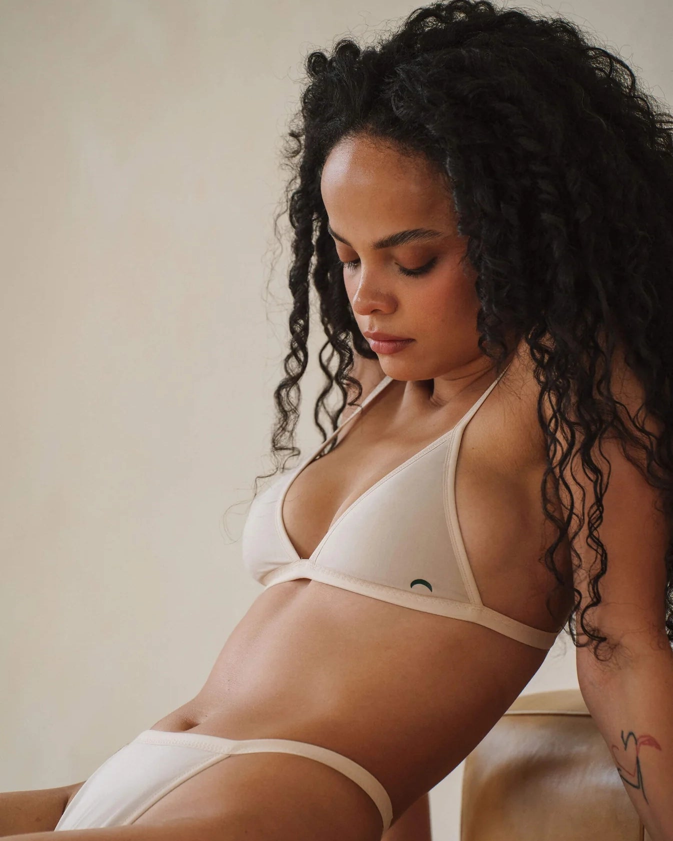 a woman wears a beige string triangle bralette with thin straps by Huha