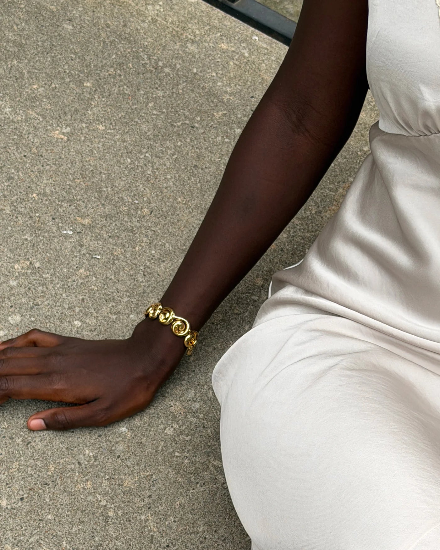 chunky statement gold bracelet with swirl details