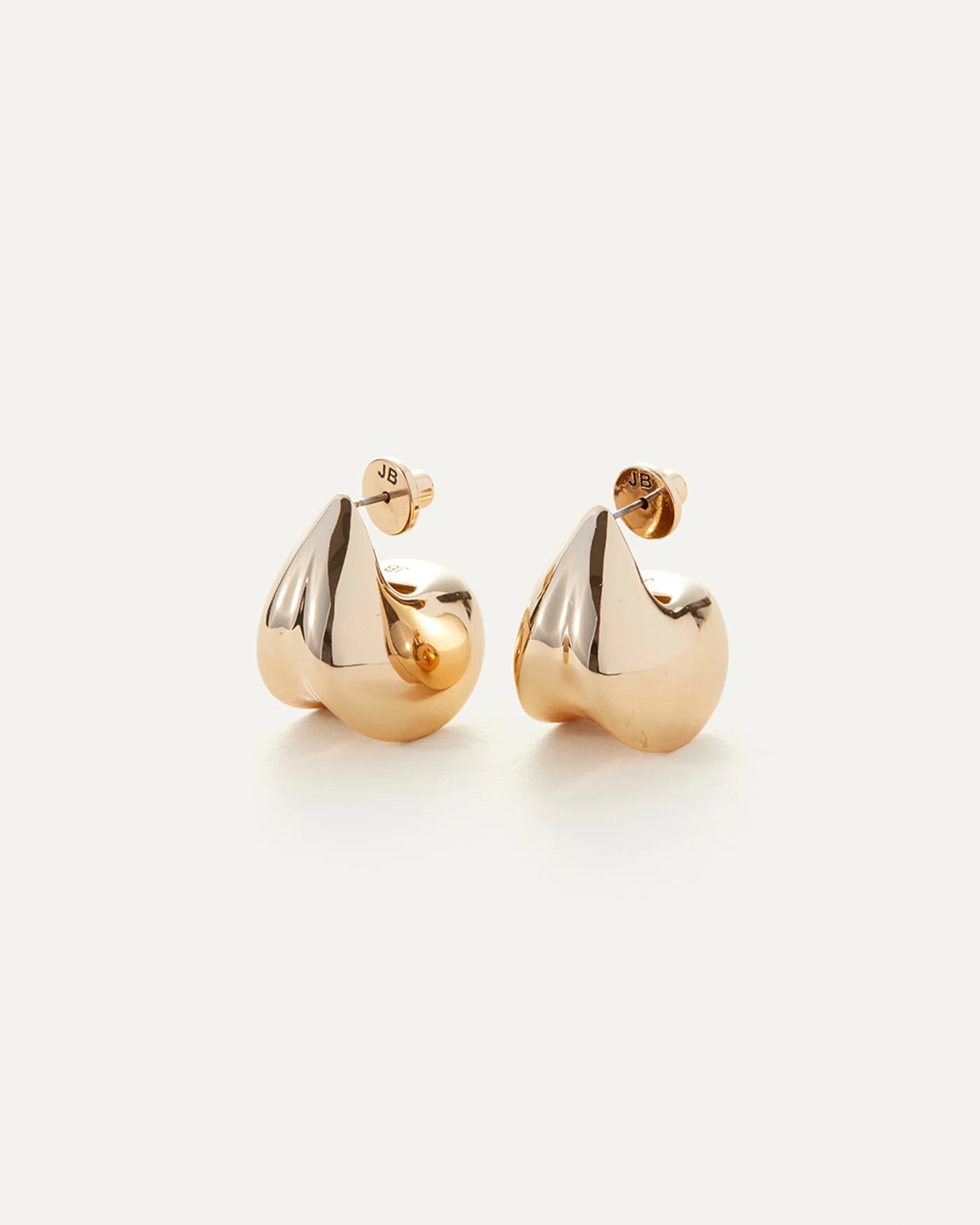 a pair of gold statement earrings by Jenny Bird