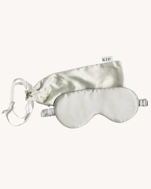 a silk sleep mask in grey with matching gift bag